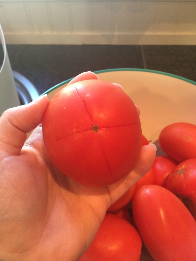 X cut into the bottom of tomatoes before blanching